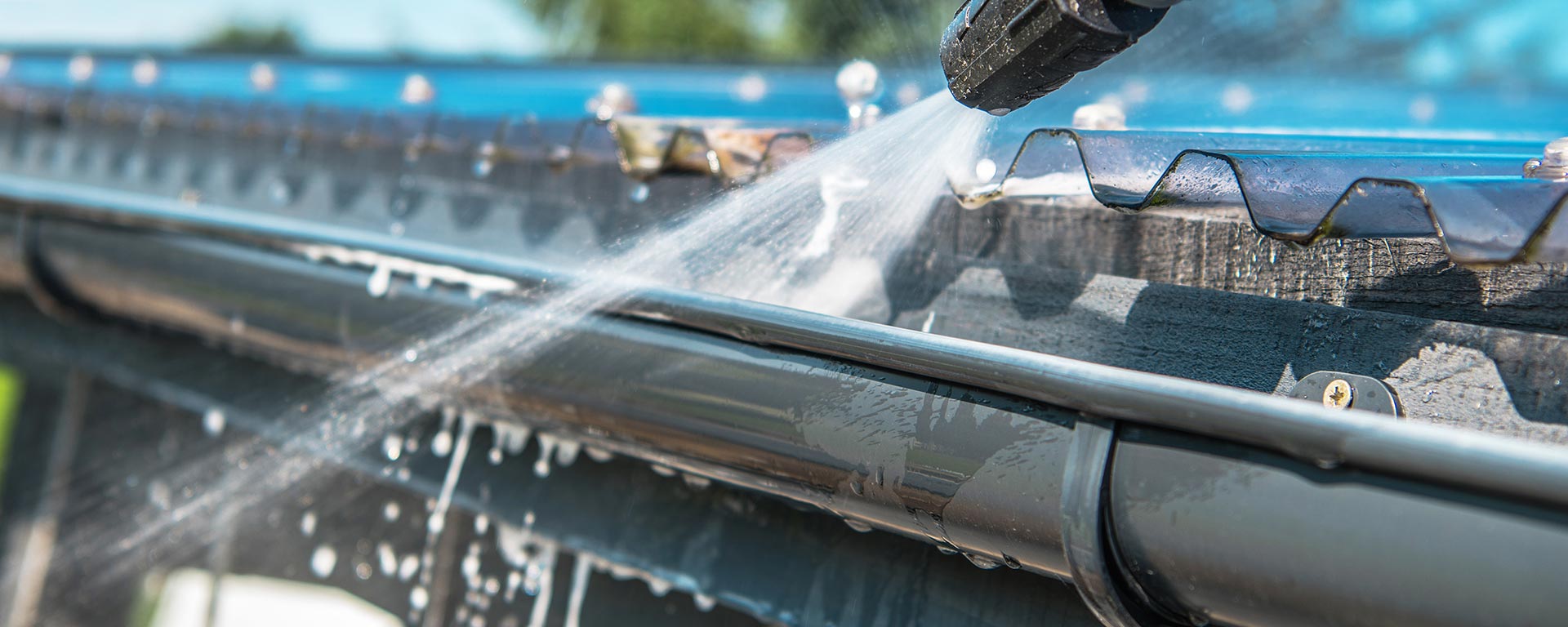 commercial-and-residential-window-cleaning-gutter-cleaning-roof-cleaning-pressure-washing-patio-gutter-being-jet-washed